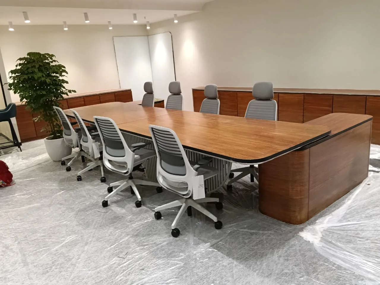 Conference room with walnut table and ergonomic chairs